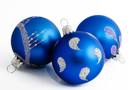 Three blue christmas balls isolated on a white background の写真素材