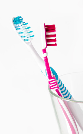 Two toothbrushes in glass isolated on white background closeupの写真素材