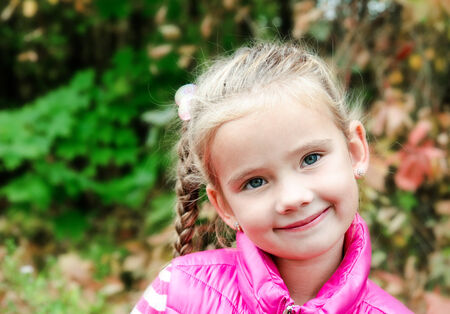 Autumn portrait of cute smiling little girl outdoor