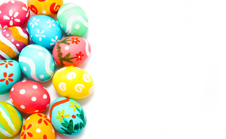 Perfect colorful handmade easter eggs in the basket isolated on a whiteの写真素材