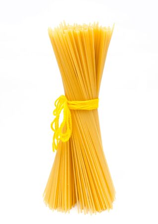 Uncooked Italian spaghetti isolated on a white backgroundの写真素材
