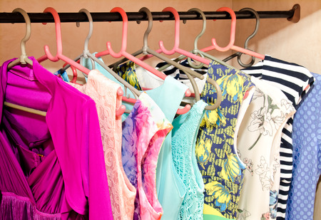 Women's dresses on hangers in the wardrobeの写真素材