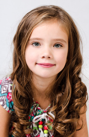 Portrait of adorable smiling  little girl isolated on a whiteの写真素材