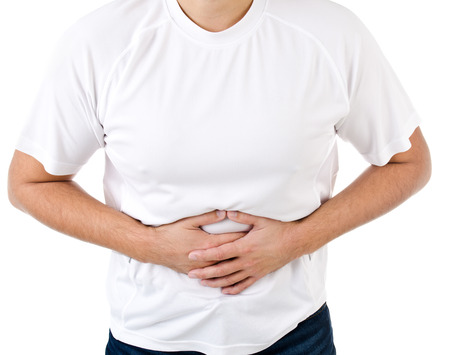 Man suffering from stomach pain isolated on a whiteの写真素材