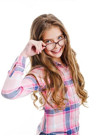 Smiling cute little girl child teen in eyeglasses education, school and vision concept isolated on a whiteの写真素材