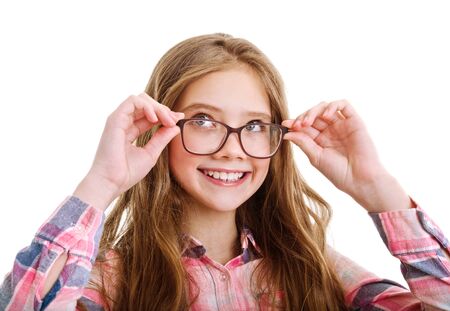 Smiling cute little girl child teen in eyeglasses education, school and vision concept isolated on a whiteの写真素材