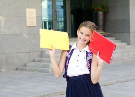 Back to school. Education concept. Cute smiling schoolgirl on the way to the school. Happy little...
