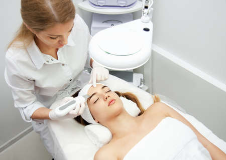 Woman getting facial beauty treatment in medical spa center. Skin care and rejuvenation concept....