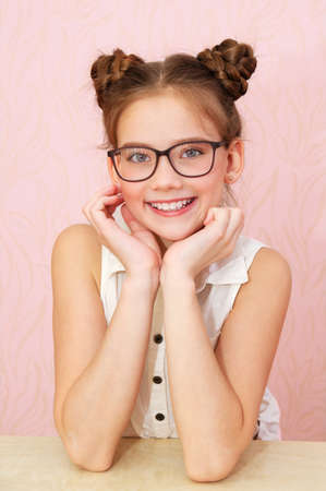 Cute little girl child preteen in eyeglasses isolated. Education, school and vision conceptの写真素材