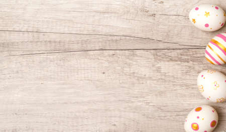 Colorful handmade painted easter eggs on a wood background. Top view and copy space for textの写真素材