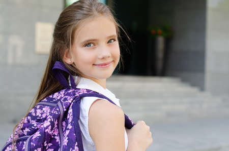 Back to school. Education concept. Cute smiling schoolgirl on the way to the school. Happy little girl child with backpackの写真素材