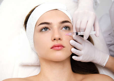 Woman getting cosmetic. injection. Beauty injections and cosmetology. Young woman in beauty salon closeup. Plastic surgery and beauty treatment.の写真素材