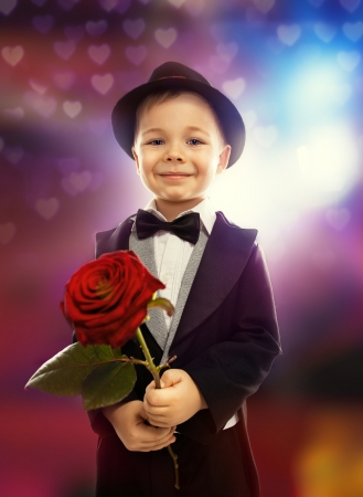 People, happiness concept  Happy little boy with roseの写真素材