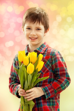 Smiling boy with a bouquet of yellow flowers   Spring, March 8, International Womens, Mothers day,...