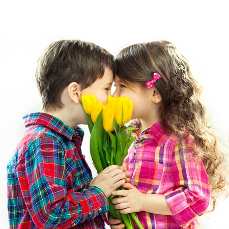 Happy boy and girl with bouquet of flowers  Spring, Mothers day, family holiday  Isolated white backgroundの写真素材