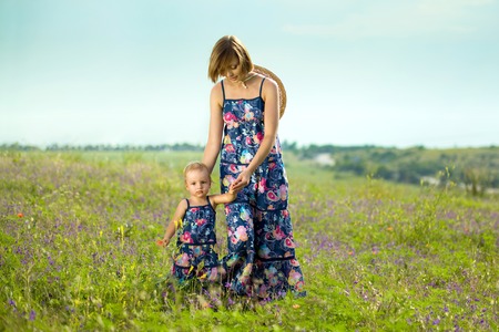 Happy mother and daughter standing in field  Outdoor shotの写真素材