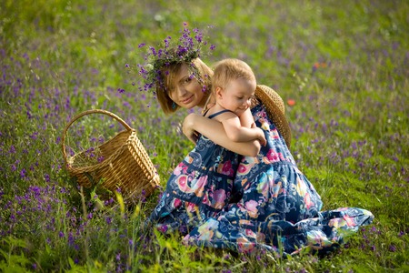 Happy mother playing with daughter in field  Outdoor shotの写真素材