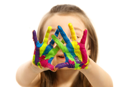 Funny little girl with hands painted in colorful paint  Isolated on white background の写真素材