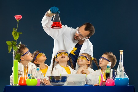 Group happy kids with scientist doing science experiments in the laboratory. Science and education.の写真素材