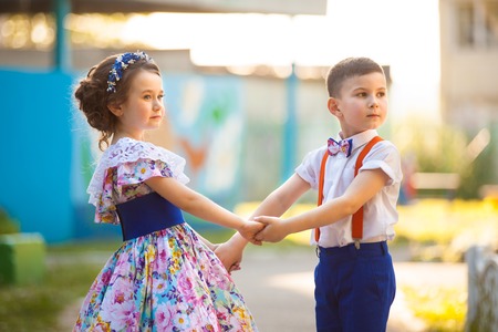 Cute boy and girl holding hands. Valentine's Day. Love storyの写真素材