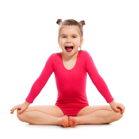 Cute little girl gymnast on a white background. Active lifestyle conceptの写真素材