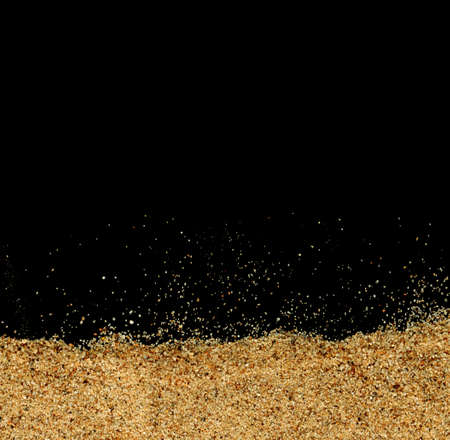 The sand on the black background close-upの写真素材