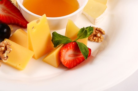 The assorted cheese with honey with strawberriesの写真素材