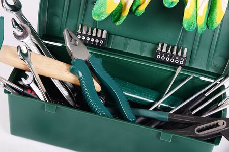 Box with construction tools isolated on whiteの写真素材