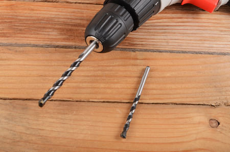 The new electric drill on wooden backgroundの写真素材