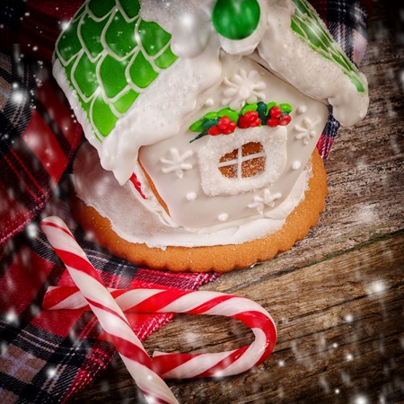 The gingerbread house on a wooden backgroundの写真素材