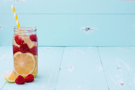 Detox fruit infused flavored water. Refreshing summer homemade cocktail. Copy space backgroundの写真素材