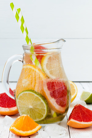 Detox citrus infused flavored water. Refreshing summer homemade cocktail with lemon, lime, orange and grapefruitの写真素材