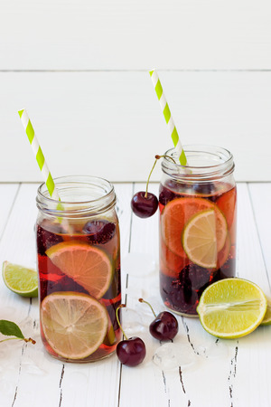 Summer refreshing homemade lemonade with cherry and limeの写真素材