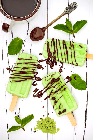 Green tea matcha mint popsicles with chocolate and coconut milkの写真素材