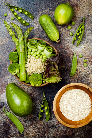Vegan, detox green Buddha bowl recipe with quinoa, cucumber, broccoli, asparagus and sweet peasの写真素材