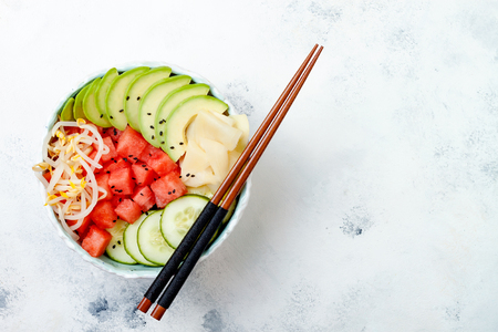 Hawaiian watermelon poke bowl with avocado, cucumber, mung bean sprouts and pickled ginger. Top view, overhead, flat lay, copy spaceの写真素材