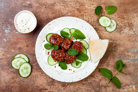Middle eastern spiced lamb meatballs with cucumber, mint and yogurt sauce. Oriental, arab cuisineの写真素材