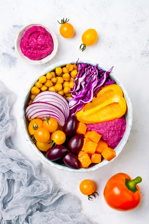 Mediterranean Buddha bowl with roasted pumpkin, olives, turmeric chickpeas, beet hummus, shredded red cabbage, yellow cherry tomatoes. Winter veggies detox bowlの写真素材
