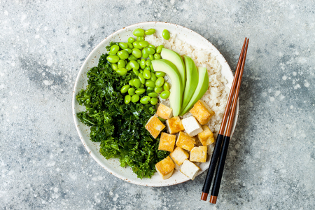 Cauliflower rice Buddha bowl with massaged kale, tofu, avocado and edamame beans. Vegan poke bowlの写真素材