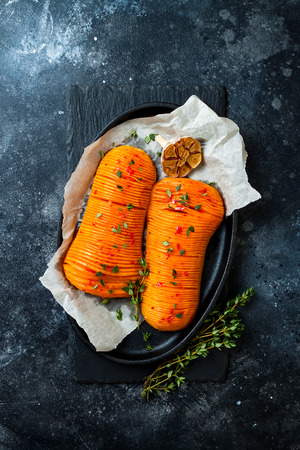 Harissa roasted hasselback butternut squash pumpkin with thyme and garlic.の写真素材