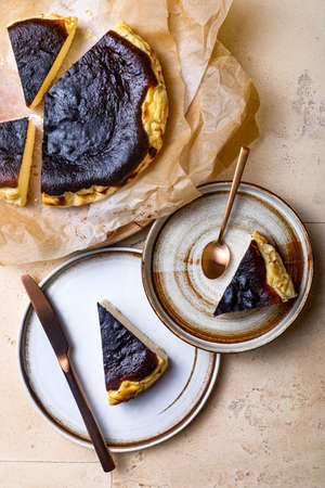 San Sebastian Basque Burnt Cheesecake. Basque burnt cheesecake on baking paper. top viewの写真素材