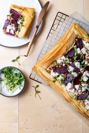 Beetroot and feta filo pizza. Beet Tart with feta, caramelized onion, pine nuts, sunflower micro greens and phyllo dough. Savory vegetable vegetable baking.の写真素材