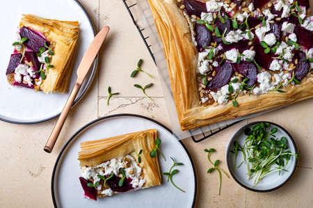 Beetroot and feta filo pizza. Beet Tart with feta, caramelized onion, pine nuts, sunflower micro greens and phyllo dough. Savory vegetable vegetable baking.の写真素材