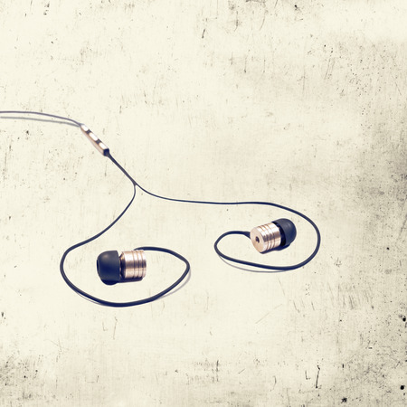 headphones stacked in heart shape on  toned scratched background executed in macro styleの写真素材