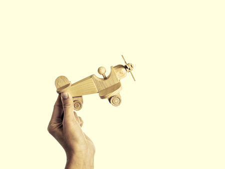 isolated image of a hand holding a wooden aircraft handmadeの写真素材