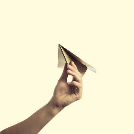 isolated image of a hand starts the paper planeの写真素材