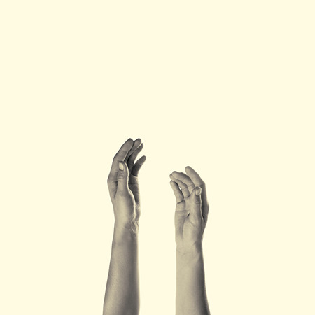 toned image of female hands raised up, isolatedの写真素材