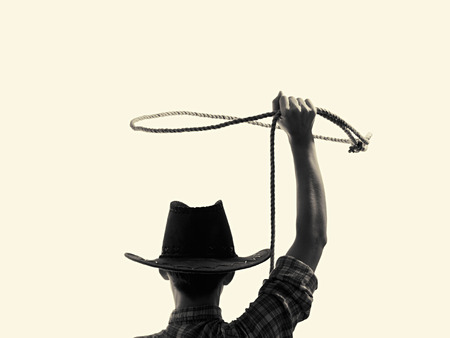 cowboy throws a lasso on the isolated backgroundの写真素材