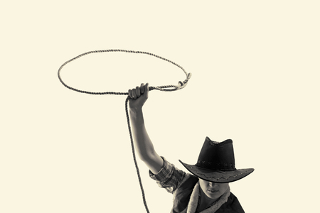 cowboy throws a lasso on the isolated backgroundの写真素材
