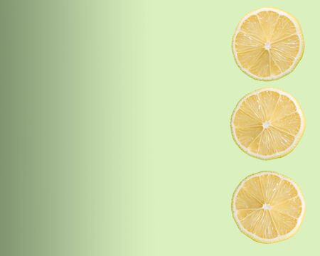three slices of a lemon close up on a green background